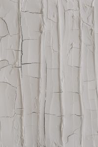 Kaboompics - Long Vertical Peeling Lines in Cracked White Paint