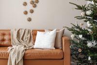 Kaboompics - Brown Sofa with Christmas Tree and Wooden Snowflake Decor