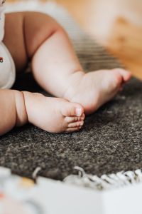 Kaboompics - Close-Up Newborn Baby Feet on Textured Dark Rug