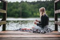 Kaboompics - Blonde woman having a healthy snack at the wooden pier