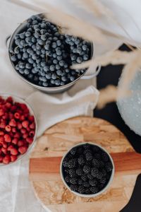 Kaboompics - Top View of Berry Bowls and a Wooden Paddle Board
