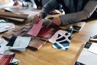 Kaboompics - Designers working with material samples and paper cutouts