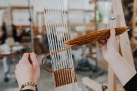 Kaboompics - Woman Weaving a Light Textile on Wooden Loom
