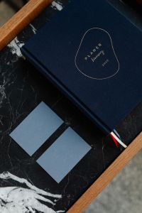 Kaboompics - Minimalist Business Card Mockup with Navy Planner on Black Marble Tray