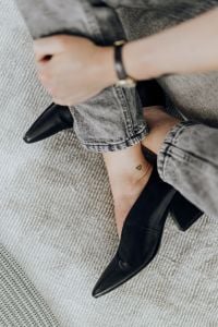 Black Pointed-Toe Heel with Gray Jeans and Wristwatch, Minimal Fashion Accessory Close-Up