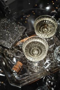 Kaboompics - Champagne Coupes, Disco Balls and Silver Tinsel on a Party Tray