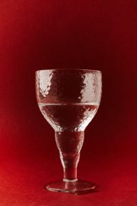 Kaboompics - Textured Wine Glass on Red Background