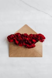 Red Carnation Flower Mail Flat Lays with White Marble Copy Space