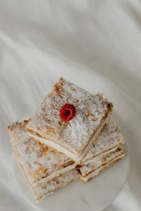 Kaboompics - Overhead Napoleonka Cake Squares with Raspberries on a White Plate