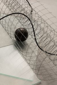Kaboompics - Dark Marble Sphere in Wire Mesh Abstract Background