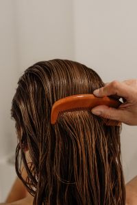 Kaboompics - Close-Up of an Orange Comb in Wet Hair
