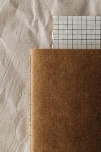 Kaboompics - Notebook Mockup With Grid Paper Neutral Background