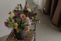 Kaboompics - Angled Floral Still Life with Dark Ceramic Vase and Woven Seat