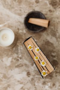 Kaboompics - Floral Book Styling with Daisies, Candle and Natural Stone