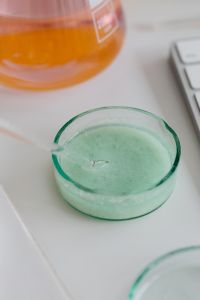 Kaboompics - Orange Chemistry Flask and Green Petri Dish Beside Keyboard