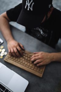 Young man typing on the wooden keyboard