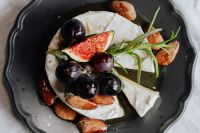Kaboompics - Close-Up Camembert Topped with Grapes, Fig and Rosemary