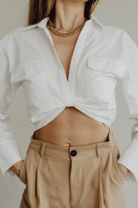 Kaboompics - Woman in White Shirt and Beige Trousers with Gold Necklace