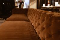 Kaboompics - Orange Velvet Sofa in a Softly Lit Interior with Background Bokeh