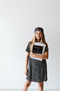 Kaboompics - Teenage Student Holding Back to School Sign