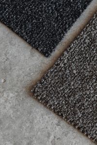 Kaboompics - Black and Brown Bouclé Upholstery Fabric Swatches on Gray Stone
