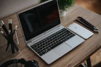 Kaboompics - Silver Acer laptop on a wooden desk with a green plant, pencils and an Apple iPhone