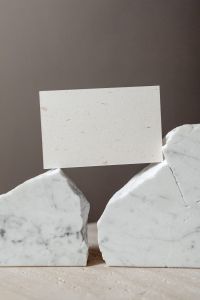 Kaboompics - Horizontal Card Mockup between White Marble Slabs on Beige Linen