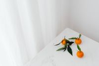 Kaboompics - Three Mandarins with Green Leaves on Marble, Minimal Citrus Background with Copy Space
