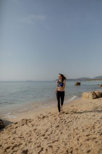 Kaboompics - Woman Walking on a Beach in Activewear