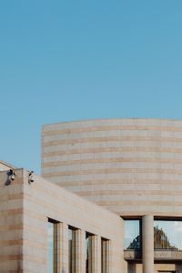 Kaboompics - Modern Curved Stone Facade on a Madrid Building Beneath Blue Sky
