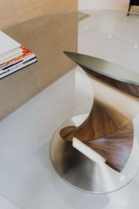 Kaboompics - Sculptural Curved Wood Table Base with Books, Interior Detail