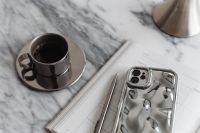 Kaboompics - Chrome Coffee Cup, Silver Phone and Chrome Dome Lamp on Arabescato Marble