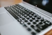 Kaboompics - Close-Up of Silver Laptop Keyboard on a Wooden Table