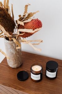 Kaboompics - Neutral Candle Product Display with Dried Botanicals and Plums for Home Fragrance Brands