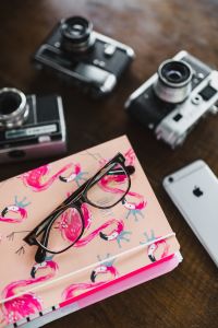 Kaboompics - Vintage Film Cameras on Wooden Desk with Pink Planner Corner, Camera Still Life
