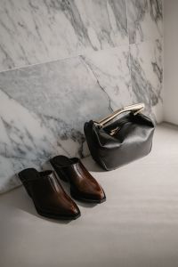 Kaboompics - Black Handbag and Brown Ankle Boots by Marble Wall