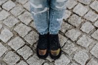 Kaboompics - Woman in black sneakers and blue jeans