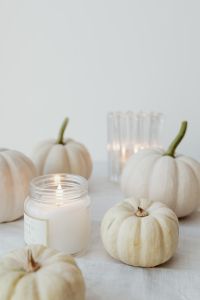 Kaboompics - White Mini Pumpkins and a Glass Candle Close Up