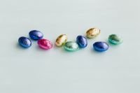 Kaboompics - Colorful Foil-Wrapped Easter Eggs in a Straight Row on White