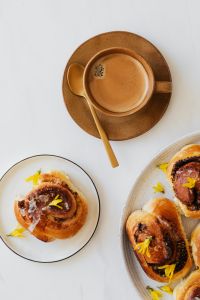 Kaboompics - Coffee Cup and Cinnamon Roll in Minimal White Flat Lay