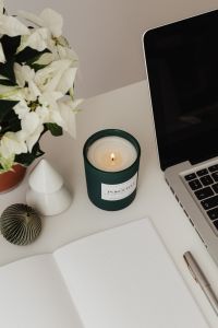 Kaboompics - Christmas Desk Styling With White Flowers and Lit Green Candle