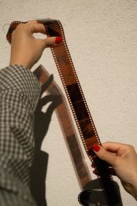 Kaboompics - Holding A Long Strip Of 35mm Film Negatives