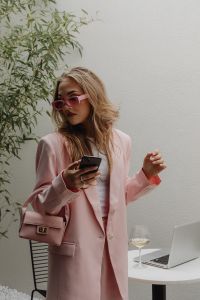 Kaboompics - Woman in Pale Pink Blazer with Phone, Handbag and Wine Glass