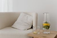 Kaboompics - Lemon and Mint Infused Water in Glass Carafe on Side Table