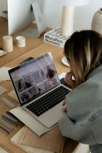 Kaboompics - Interior Designer Working on Laptop with Material Samples and Moodboard