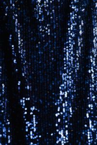 Kaboompics - Navy Sequin Fabric with Vertical Lines of Blue-White Sparkle, Dark Background