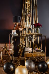 New Year's Eve Party Decor and Backgrounds with Champagne, Gold Streamers, Balloons and Roses