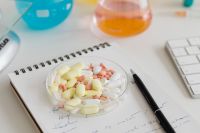 Kaboompics - Tablets, Laboratory Flask and Keyboard on White Desk