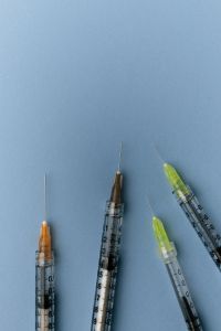 Kaboompics - Minimal Syringes on Blue Background