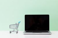 Kaboompics - Online Shopping Concept with Laptop and Mini Cart on Mint Background